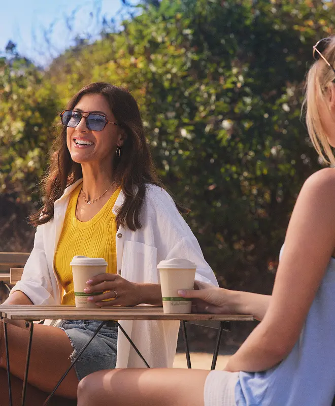 Hypothetical EKTERLY® (sebetralstat) patient sitting outside with a drink