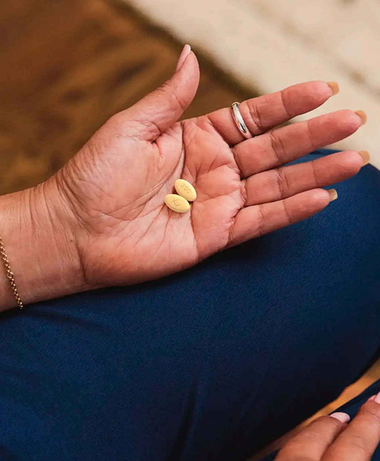 Hypothetical patient holding an EKTERLY® (sebetralstat) tablet